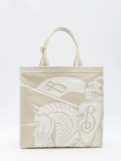 Lightweight grey canvas tote bag with a jacquard Equestrian Knight Design. Equipped with fixed double handles, a main interior compartment and a detachable zipped pouch.. Dimensions: 15.x5x14.5 inches Size nationality: UNI Product number: 1989953 Product code: 8093183B7733 Composition: 59% polyurethane, 41% cotton Burberry Tote Bag, Knight Design, Burberry Tote, Designer Totes, White Tote, Shopping Tote Bag, Personalized Accessories, Shopper Bag, Shopping Tote