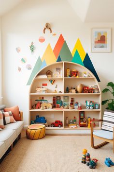 a child's playroom with toys, bookshelf and couch in it