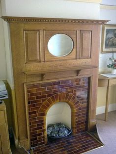 a living room with a fire place in the center and a mirror on top of it