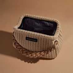 This exquisite Raffia Paloma Shoulder Bag is carefully crafted from luxuriously natural raffia intertwined with a slim leather and chain shoulder strap. Ornamented with a chunky acrylic chain for a unique touch, this timeless piece features a black lining and interior zipper pocket for extra security. Complete with a branded dust bag, this handbag is crafted with Italian finesse and is the perfect summer accessory. This new edition of this Paloma Bag has been updated so that the acrylic chain ca Crochet Leather Bag, Unique Handbags Fashion Bags, Crochet Luxury Bag, Crochet Luxury, Nickel And Suede, 2024 Wishlist, Unique Handbags, Crochet Business, Handbags Fashion