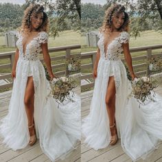 a woman wearing a white wedding dress standing on a deck with flowers in her hand