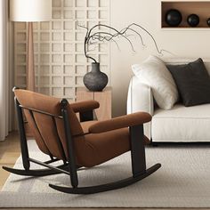 a living room with a white couch and brown rocking chair