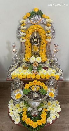 the altar is adorned with yellow and white flowers