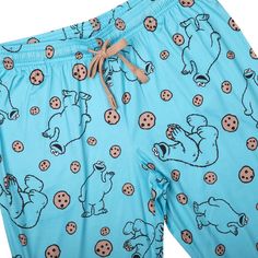 Indulge in the whimsy and charm of Sesame Street with our officially licensed Cookie Monster Blue Adult Juniors Sleep Pants. These delightful blue sleep pants feature an all-over repeat print of the iconic Cookie Monster enjoying his favorite treat - cookies! Perfect for fans of this beloved character, these pants offer a cozy and comfortable fit with a blend of 92% polyester and 8% Spandex. The elastic waistband and drawstring allow for a secure and adjustable fit, while the practical side pock Sesame Street Cookies, Sesame Street Cookie Monster, Repeat Prints, Sleep Pants, Pants Large, Fabric Tape, Favorite Cookies, Cookie Monster, Monster Cookies