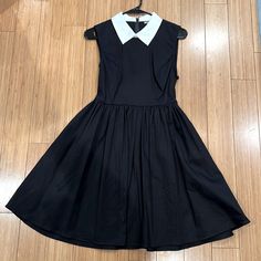 Black Collared Dress From Hot Topic With A Tie String Waist And Zip Closure Down Center Of Back. A-Line Style With A Cinched Waist And Full Skirt. Length Hits Right Above Knee (I’m 5’4 For Reference) Size Medium. Dress Has Been Washed But Never Worn. Classic Black Collared Mini Dress, Black Collared Summer Dress, Classic Black Dress For Dress Down, Classic Black Dress For Casual Wear, Classic Black Dress For Spring, Black A-line Dress For Daywear, Classic Black Summer Dress, Black Collared Dress, Hot Topic Dresses