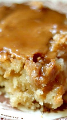 a close up of a piece of cake on a plate with caramel toppings