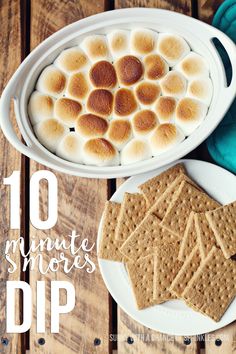 a white plate topped with s'mores next to a bowl of dip