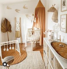 a baby's room is decorated in white and neutrals with birds on the wall