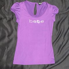 Nwot Vibrant Purple Bebe Tee. Beautiful Shiny Satiny Material. Cute Cap Sleeves. Y2k Letter Print Tops For Night Out, Y2k Tops With Letter Print For Night Out, Y2k Style Tops With Letter Print For Night Out, Purple Stretch Tops With Letter Print, Stretch Purple Tops With Letter Print, Fitted Letter Print Tops For Night Out, Stretch Letter Print Top For Night Out, Stretch Top With Letter Print For Night Out, Purple Baby Tee