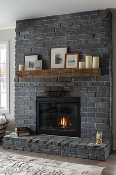 a living room with a fireplace and pictures on the mantle