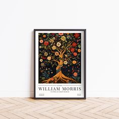 a framed poster with an image of a tree and flowers on the bottom, in front of a white wall