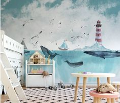 a child's room decorated in blue and white with a lighthouse mural on the wall