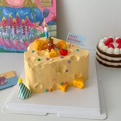 a birthday cake with teddy bears on it next to a greeting card and a bear figurine