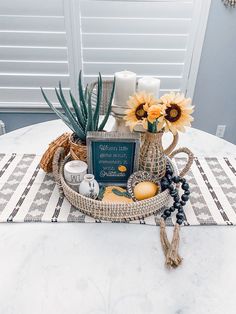 a table topped with a vase filled with flowers and other items on top of it