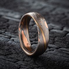 "* Price may vary depending on ring size, please inquire with us directly with your needed size for accurate pricing! This lovely rustic Mokume Gane ring is shown in the Twist pattern and Embers Palette, with a low dome profile and an etched and oxidized finish. The Embers palette features Red Gold, Palladium and Sterling Silver. And this ring has an added yellow gold stratum layer for an extra touch of color! Pattern: Twist Palette: Embers Finish: Etched & Oxidized Profile: Low Dome  Width Shown: 6mm Size Shown: 9 **Price does NOT include stones, or setting fees. We care about customer service and would like to hear from you! Please contact us to help create your treasured item, we take your concerns and requests to heart and will work together to create your unique designs SPECIAL PRICIN Mokume Gane Ring, Costume Rings, Twist Pattern, Mokume Gane, Custom Wedding Rings, Silver Band, Cute Jewelry, Red Gold, Precious Metals