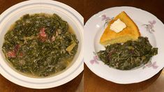 there is a bowl of soup and a plate with bread on the table next to it