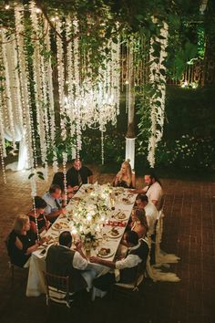 a group of people sitting around a dinner table