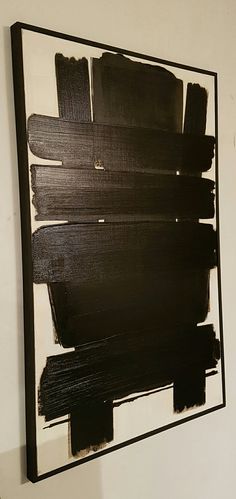 an abstract painting is displayed on the wall