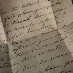 an old handwritten letter on top of a piece of paper