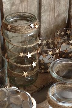 some glass jars with gold stars on them