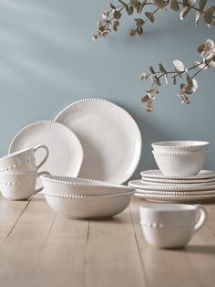 white dishes and cups on a wooden table