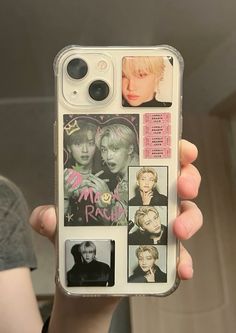 a person holding up a cell phone case with many pictures on the back of it