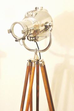 an old fashioned wooden tripod lamp on a white background