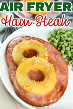 an air fryer ham steak with pineapples and green peas on the side