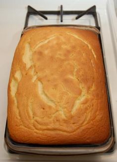 a loaf of bread sitting on top of a metal pan next to a white counter