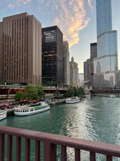 boats are parked along the river in front of tall buildings and other large skyscrapers