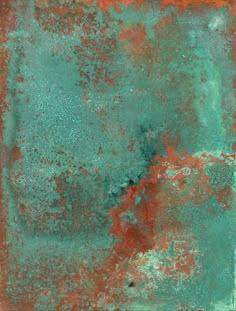 an old rusted metal surface with red and green paint