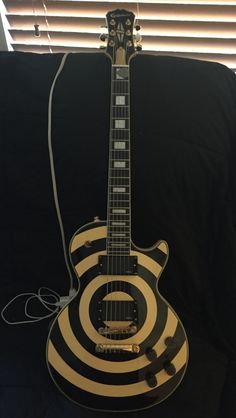 an electric guitar with black and white stripes on it