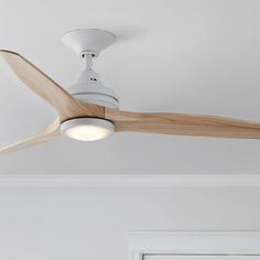 a white ceiling fan with wooden blades in a room