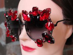 ADULT oversized circle/round sunglasses with black metal frames and dark smoke lens, embellished with big and beautiful scarlet red glass rhinestone gems. Please note this pair is quite heavy due to the size and amount of rhinestones. These bedazzled beauties offer bold and exciting looks for sunny days. Custom colors, styles, and frames available by request.  These glasses offer UV 400 protection. Luxury Red Sunglasses For Formal Occasions, Luxury Red Rhinestone Jewelry, Elegant Red Glass Sunglasses, Red Rhinestone Sunglasses, Red Rectangular Sunglasses With Mirrored Lenses, Circle Sunglasses, Red Glasses, Black Metal Frame, Red Crystals