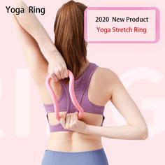 a woman holding a pink yoga ring in front of her back with the words yoga ring on it