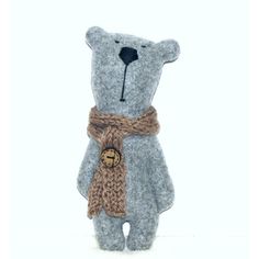 a gray teddy bear with a scarf around it's neck