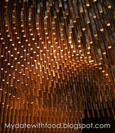 the ceiling is made out of bamboo sticks and has many holes in it that are hanging from