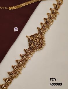 This exquisite waistband is meticulously crafted with shimmering stones, radiating a mesmerizing brilliance that catches the eye. Adorned with intricate detailing and a regal design, it adds a touch of opulence and grace to your waistline. Perfect for weddings and special occasions, this waistband effortlessly accentuates your attire, creating a captivating and glamorous look. Gold Temple Jewelry Style Bridal Belt For Wedding, Ceremonial Temple Jewelry Bridal Belt With Tilla, Festive Temple Jewelry Bridal Belt For Wedding, Traditional Gold Bridal Belt With Tilla, Traditional Gold Bridal Belt For Festivals, Elegant Gold Temple Necklace With Motifs, Gold Temple Jewelry Bridal Belt For Festive Occasion, Gold Bridal Belt For Wedding And Diwali, Festive Gold Bridal Belt In Temple Jewelry Style