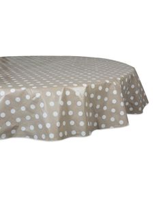 a round table with white polka dots on the top, and a light brown cloth over it