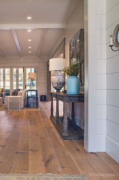 a living room with wood floors and white walls