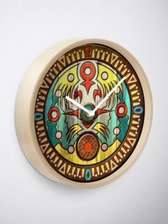 a clock that is on the wall with an artistic design painted on it's face