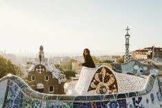 a woman standing on top of a tiled roof