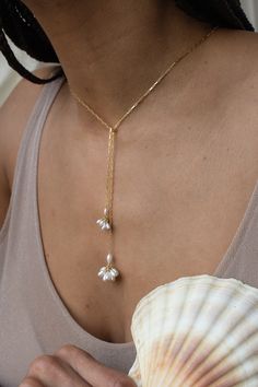 A minimalistic approach to pearls - the Fleurette Tie Necklace features hand-fabricated, fleurette clusters of freshwater pearls dangling from a 14k gold filled or sterling silver chain. There is no clasp, just loop and go! PLEASE SELECT DESIRED LENGTH FROM DROPDOWN Materials: 14K gold filled or sterling silver Earring: 14k gold filled or sterling silver post Measures: approximately 19" or 24" in length. Custom measurements are available, please send an email Handmade in New York Arrives perfectly packaged, ready for gift-giving! Earrings shown are separately. Shown in 24" length Pearl Lariat Necklace, Elizabeth Jewelry, Pearl Lariat, Tie Necklace, Modern Necklaces, Lariat Necklace, Drop Necklace