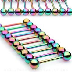 several colorful metal balls are attached to the back of a pair of hair pins on a white background