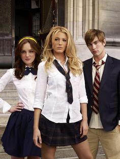 three young people in school uniforms posing for the camera