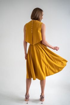 Mustard yellow dress consists of three parts - a top, an A-shaped skirt and an overtop. You can choose the top with or without the nursing option. The overtop is specially made for more discreet nursing but will also serve as an eye-catching accent even without the nursing option and will give you a well put together look. The dress has pockets and it can be transformed into three parts and worn separately so this set is perfect for traveling or as a sustainable piece in your capsule wardrobe. This timeless dress will live in your wardrobe forever due to the elegant and always-in-fashion fit. Materials: 60% viscose, 35% polyamide, 5% elastane, lining is made from 95% polyamide and 5% elastane. 34 = XS 36 = S 38 = M 40 = L 42 = XL 44 = XXL THIS DRESS CAN BE ORDERED BY STANDARD SIZING CHART Yellow Full Skirt Dresses For Summer, Chic Sleeveless Mustard Midi Dress, Chic Mustard Sleeveless Midi Dress, Mustard Summer Dresses For Workwear, Chic Mustard Dress For Work, Fitted Mustard Dress For Daywear, Mustard Chic Dress For Work, Chic Mustard Workwear Dress, Dark Yellow Dress