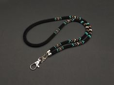 "The Handmade Native Inspired Beaded Lanyard is a meticulously crafted accessory that effortlessly combines style and functionality. This unique lanyard is individually handcrafted using premium materials such as high-quality Japanese toho beads, cotton threads, metal findings, and infused with the artisan's own creativity, love, and passion.  Highlights - Handmade: Each lanyard is carefully handcrafted, ensuring attention to detail and providing a one-of-a-kind piece. - Native Inspired: The intricate beadwork showcases a captivating design inspired by indigenous cultures, adding an ethnic touch to your attire. - Length: With a total length of 15.5 inches, this lanyard is perfectly sized to hang comfortably around your neck while keeping your essentials within reach. - Breakaway Feature: T Everyday Black Beaded Jewelry, Black Beaded Adjustable Lanyards, Handmade Black Lanyards, Black Beaded Lanyards As Gift, Black Beaded Lanyard As Gift, Black Beaded Lanyards For Gift, Unique Lanyard, Beaded Lanyard, Toho Beads