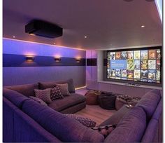 a living room filled with furniture and a flat screen tv mounted to the wall above it