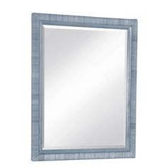 a blue framed mirror on a white wall