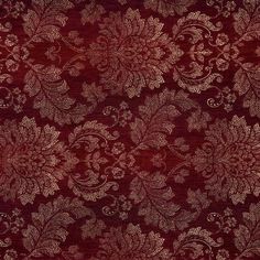 a red and gold floral pattern on fabric